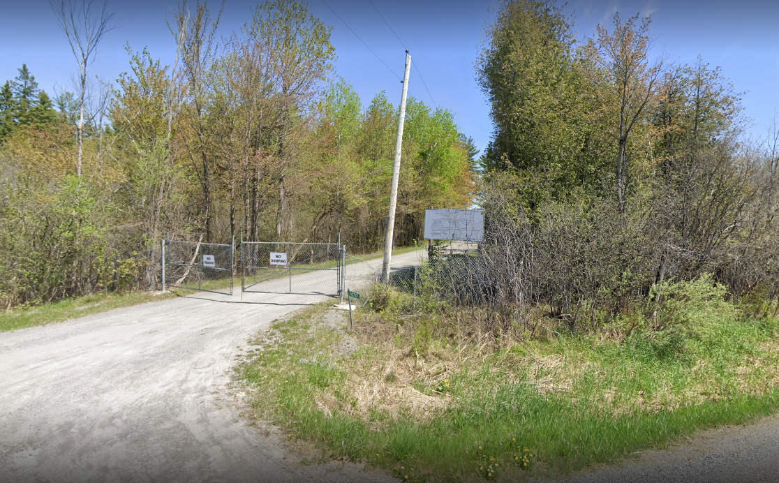 Waste and recycling depot fenced in with no dumping sign