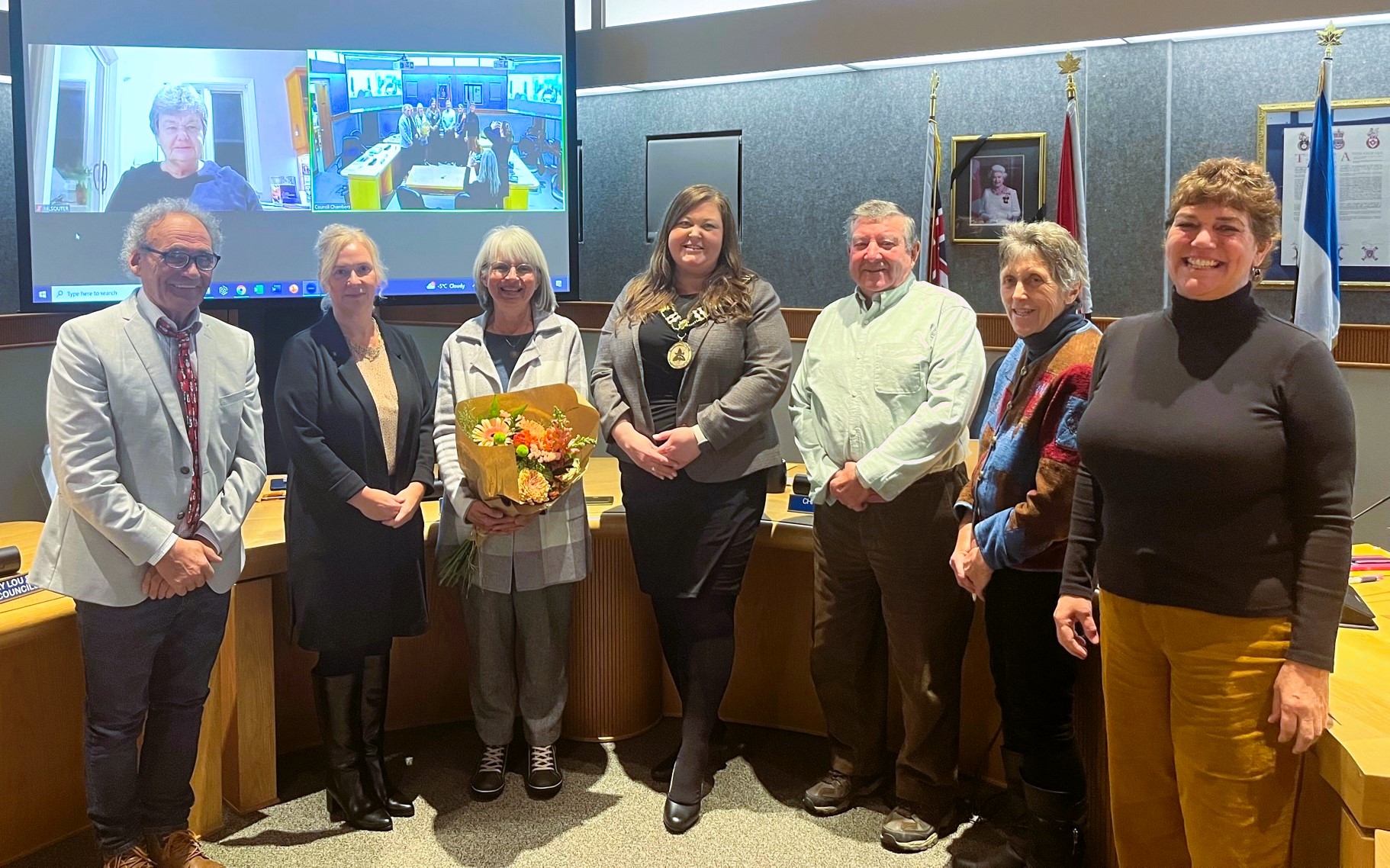Mississippi Mills Council members stand in front of desks with retiring librarian, Monica Blackburn