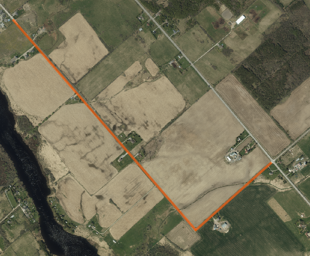 Satellite image of rural area with a section marked in orange-red