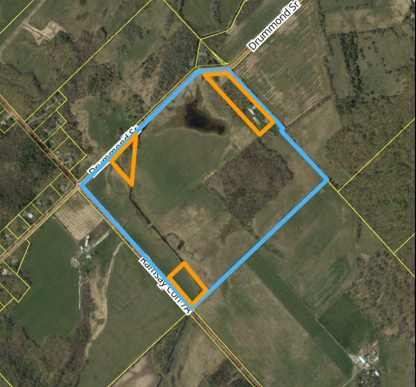Satellite view of a rural property outlined in blue. Three other sections inside that area are outlined in orange.