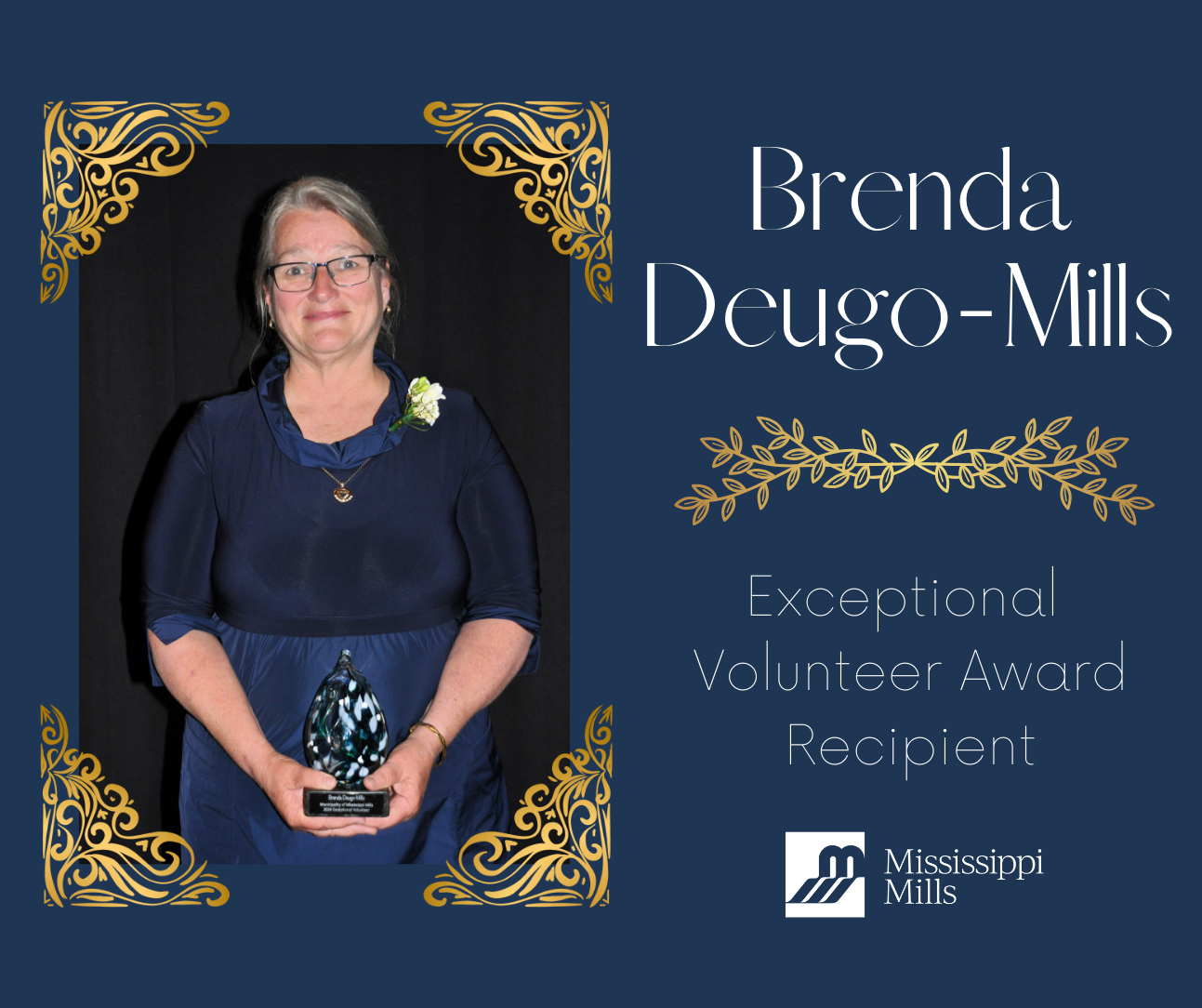 Dark blue and gold graphic with a photo of a woman in dark clothes holding a glass award. Text reads 'Brenda Deugo-Mills, Exceptional Volunteer Award Recipient'