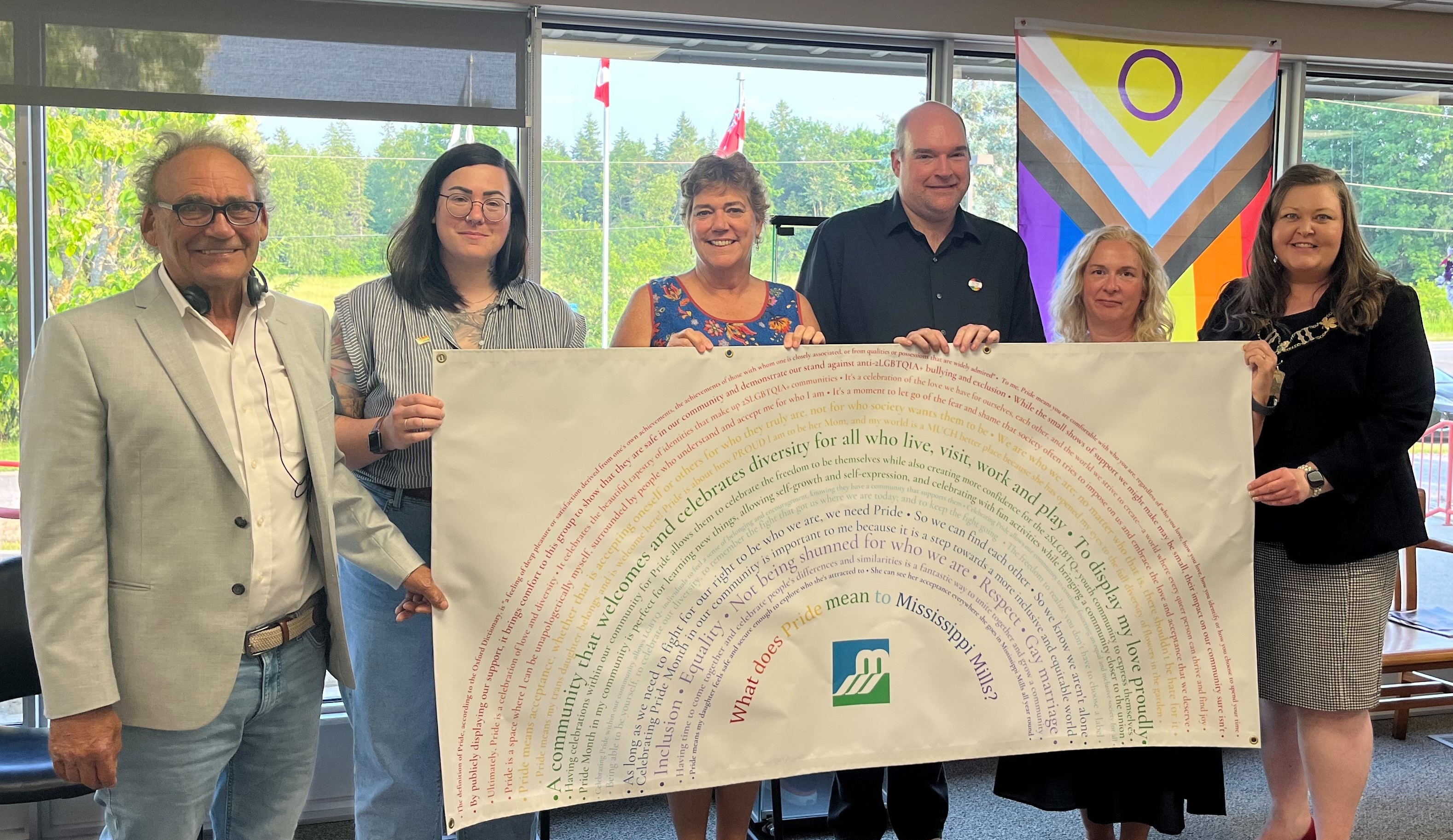 Group stands with banner