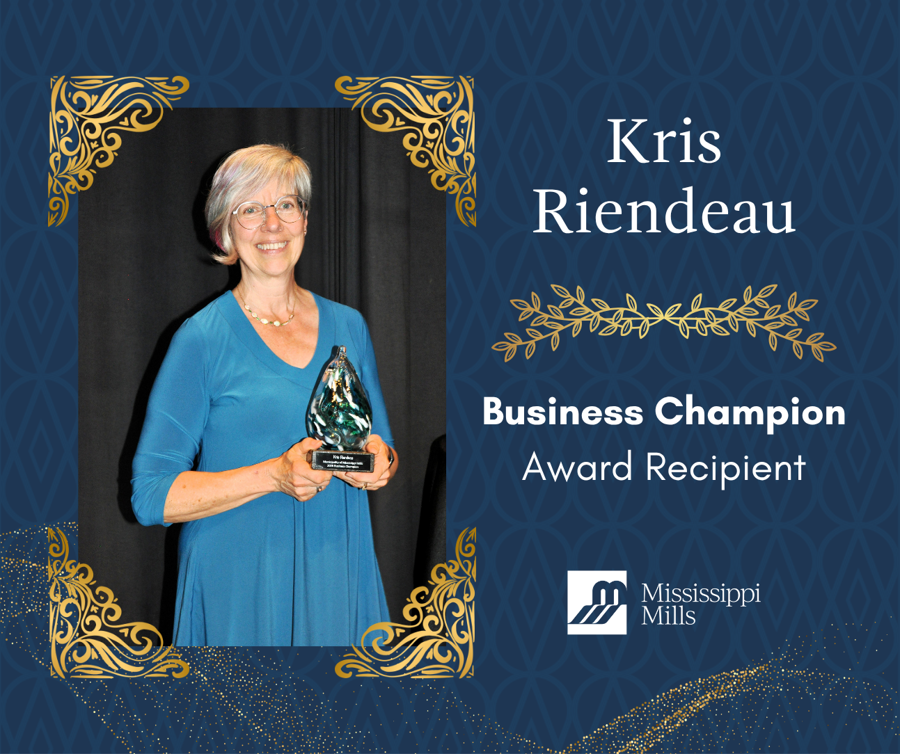 Navy background with gold accents displays a photo of a woman with silver hair and glasses, wearing a blue dress, smiling and holding an award. White text reads 'Kris Riendeau - Business Champion Award Recipient.'
