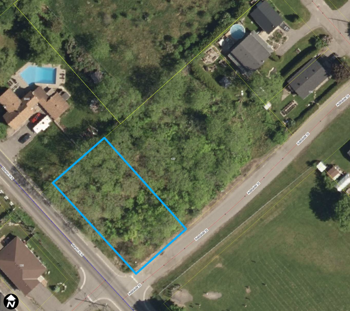 Satellite image showing a residential lot, marked out in a blue box.