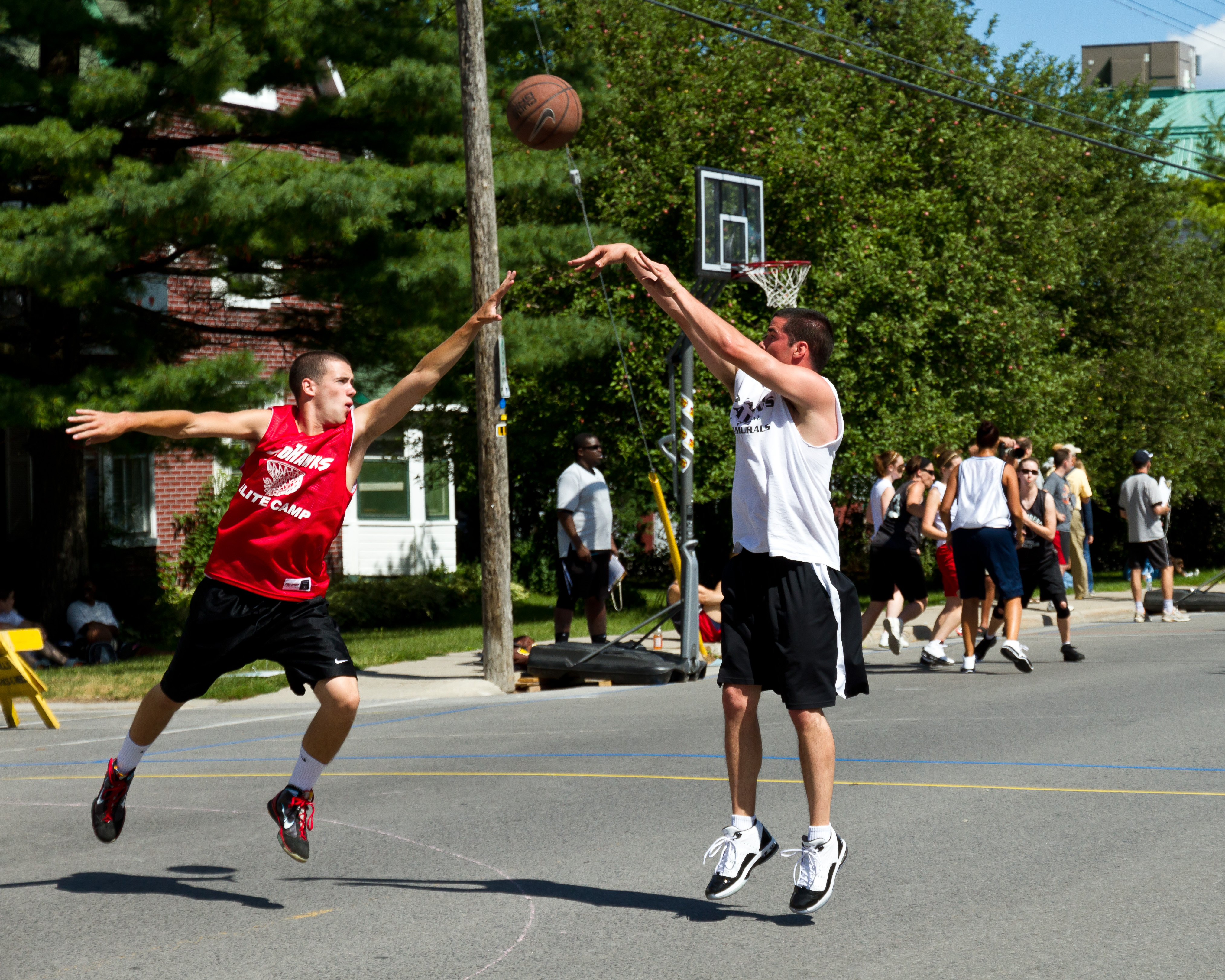 Two youths playing basketball on the street