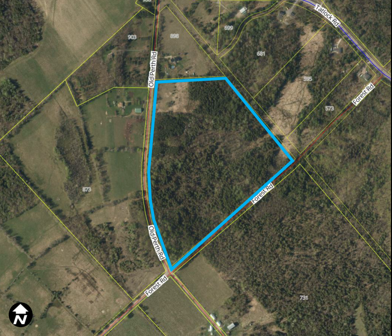 Satellite image of a rural area with a property outlined in blue.