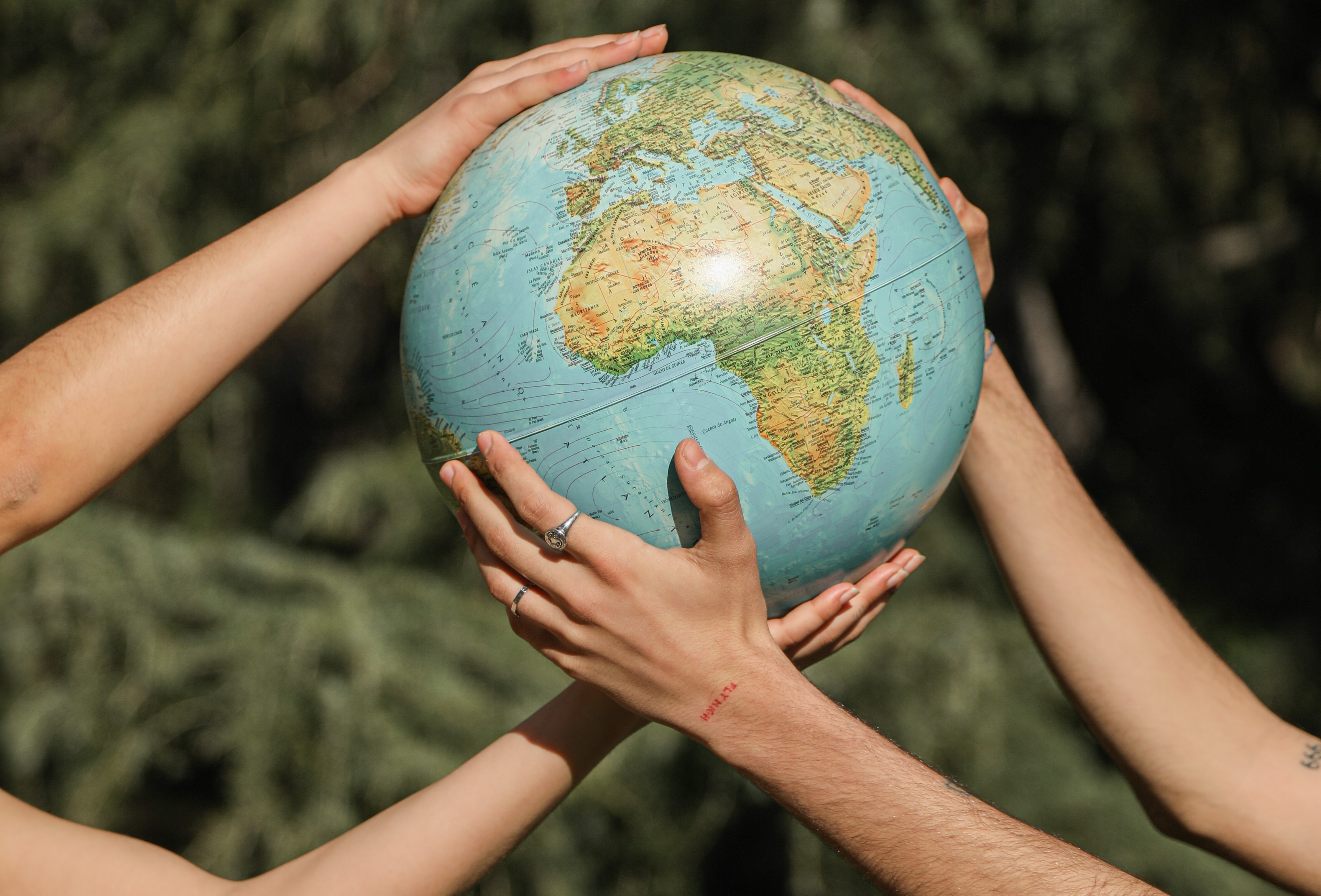 People holding globe