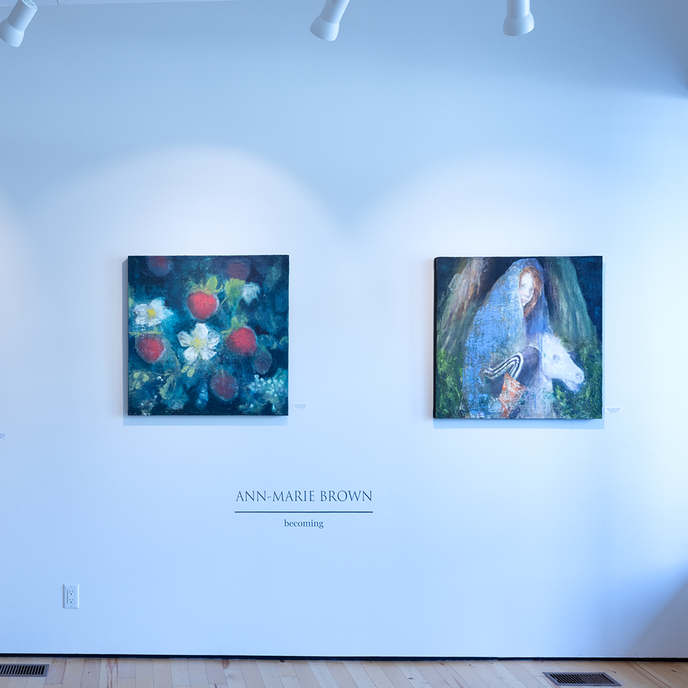Photo of two paintings on a blue wall
