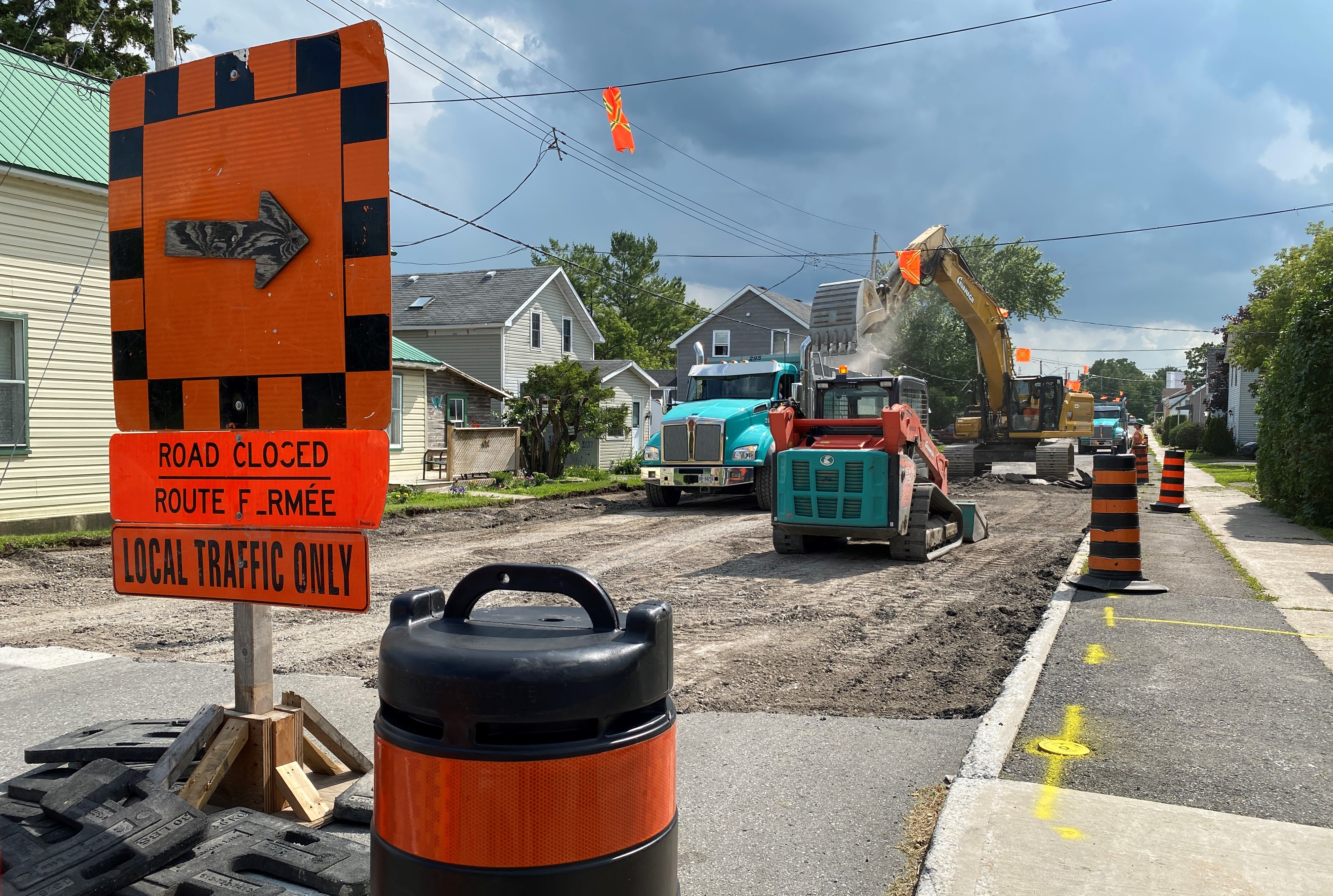 Excavators and equipment dig up a road during construction