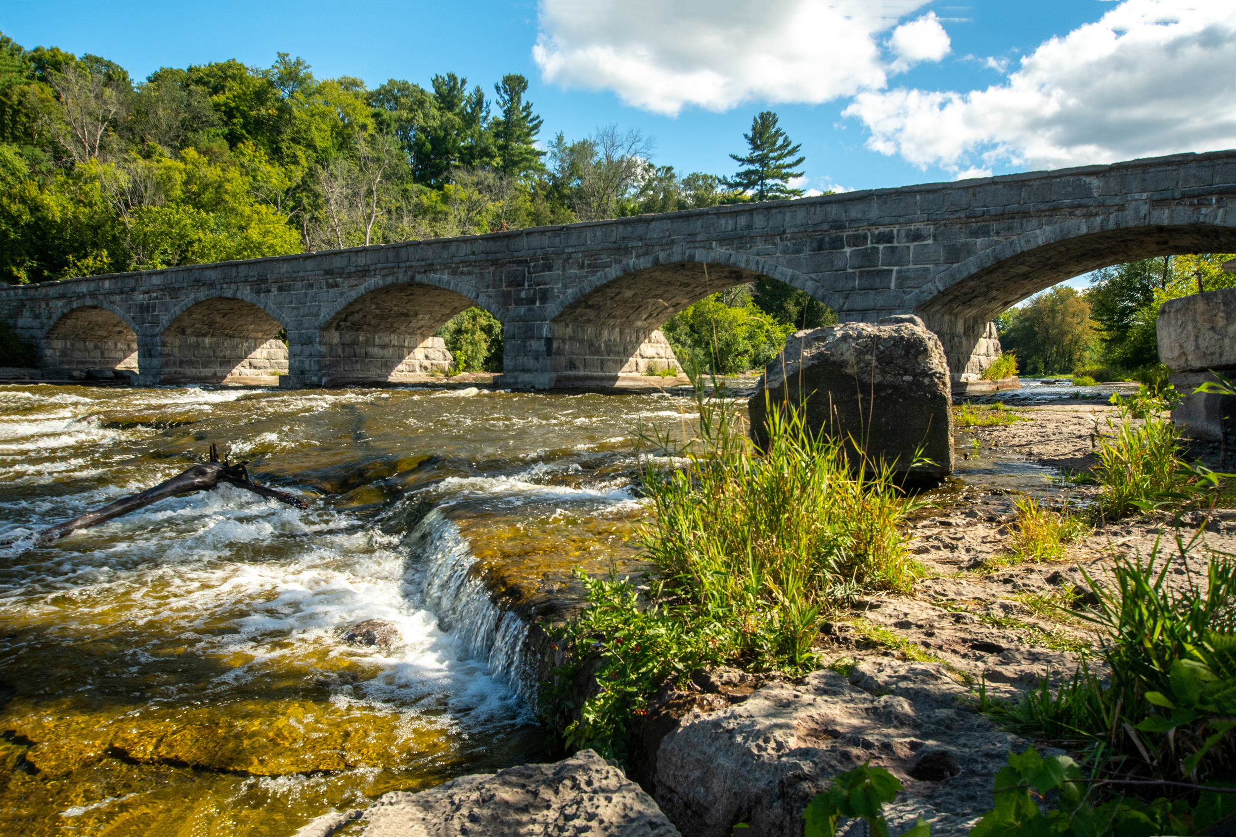 Photo of stone bridge with water running underneath