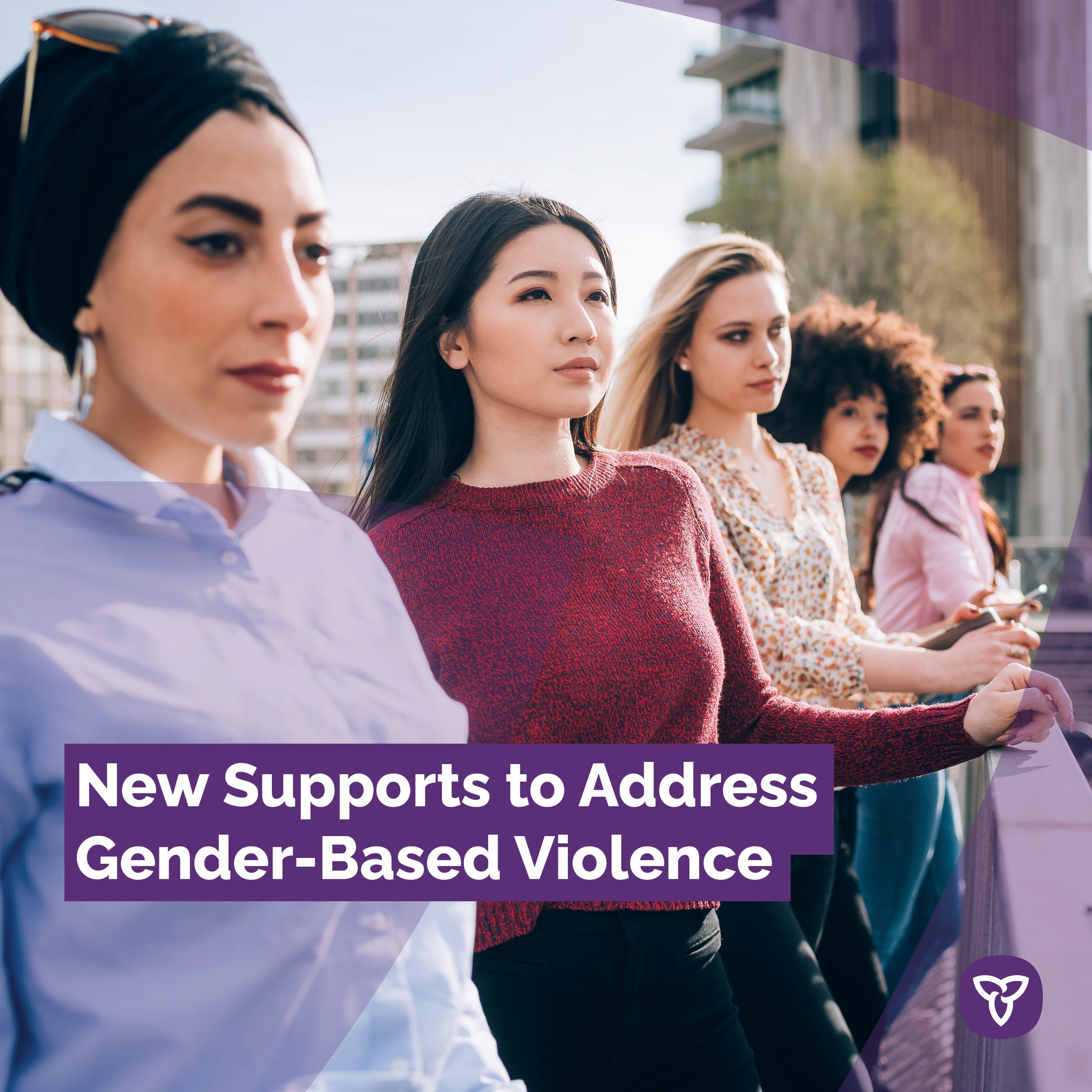 Photo of five women standing against the railing of a bridge. Text reads 'New supports to address gender-based violence.'