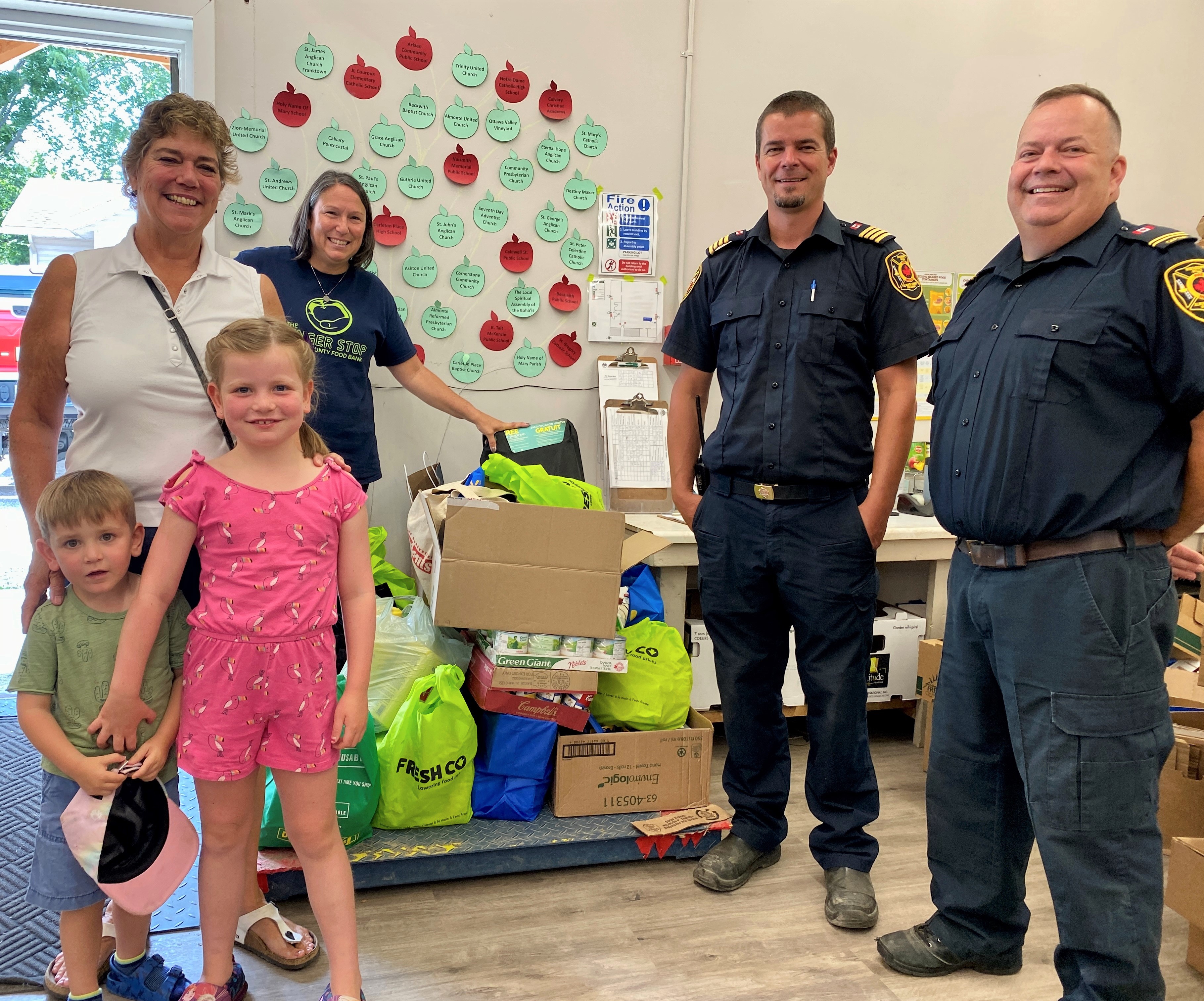 Group stands around food donations
