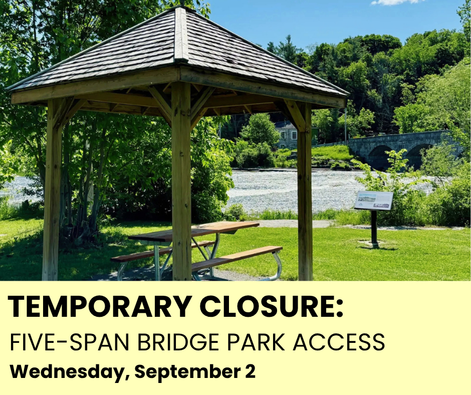 A wooden gazebo in a park with a picnic table underneath. In the distance, a river runs. A yellow box with black text reads 'Temporary Closure: Five-Span Bridge Park Access - Wednesday, September 2.'