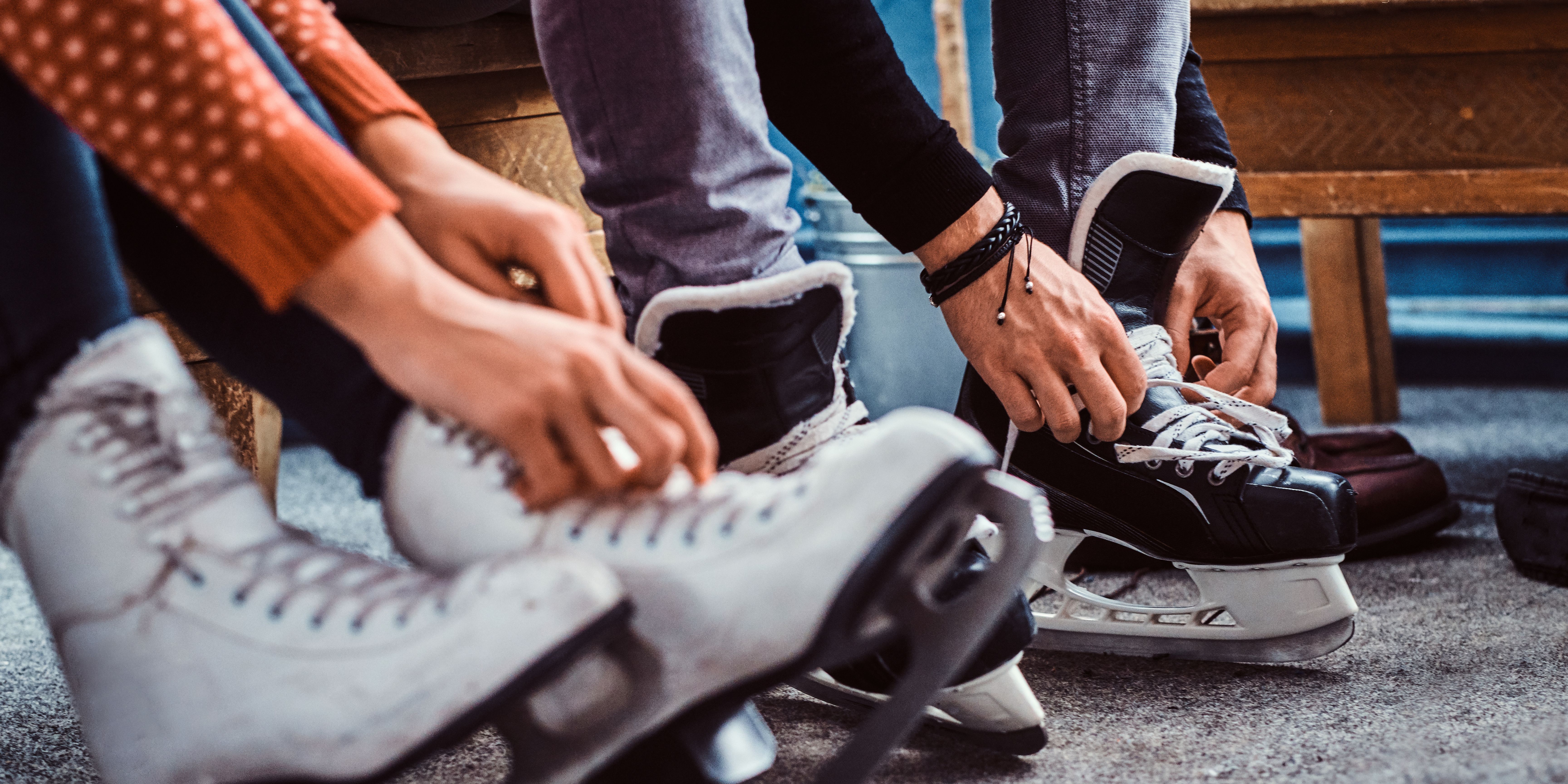 People lacing up ice skates
