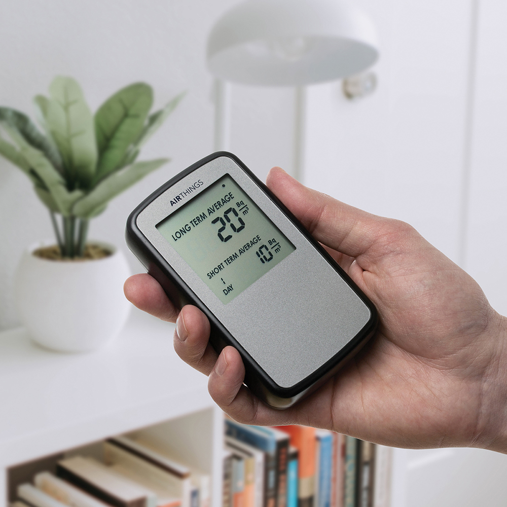 hand holding a digital radon detector