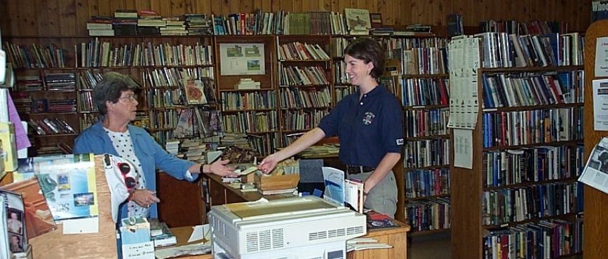 Inside of old Port Carling library with librarian Betty Glen and borrower