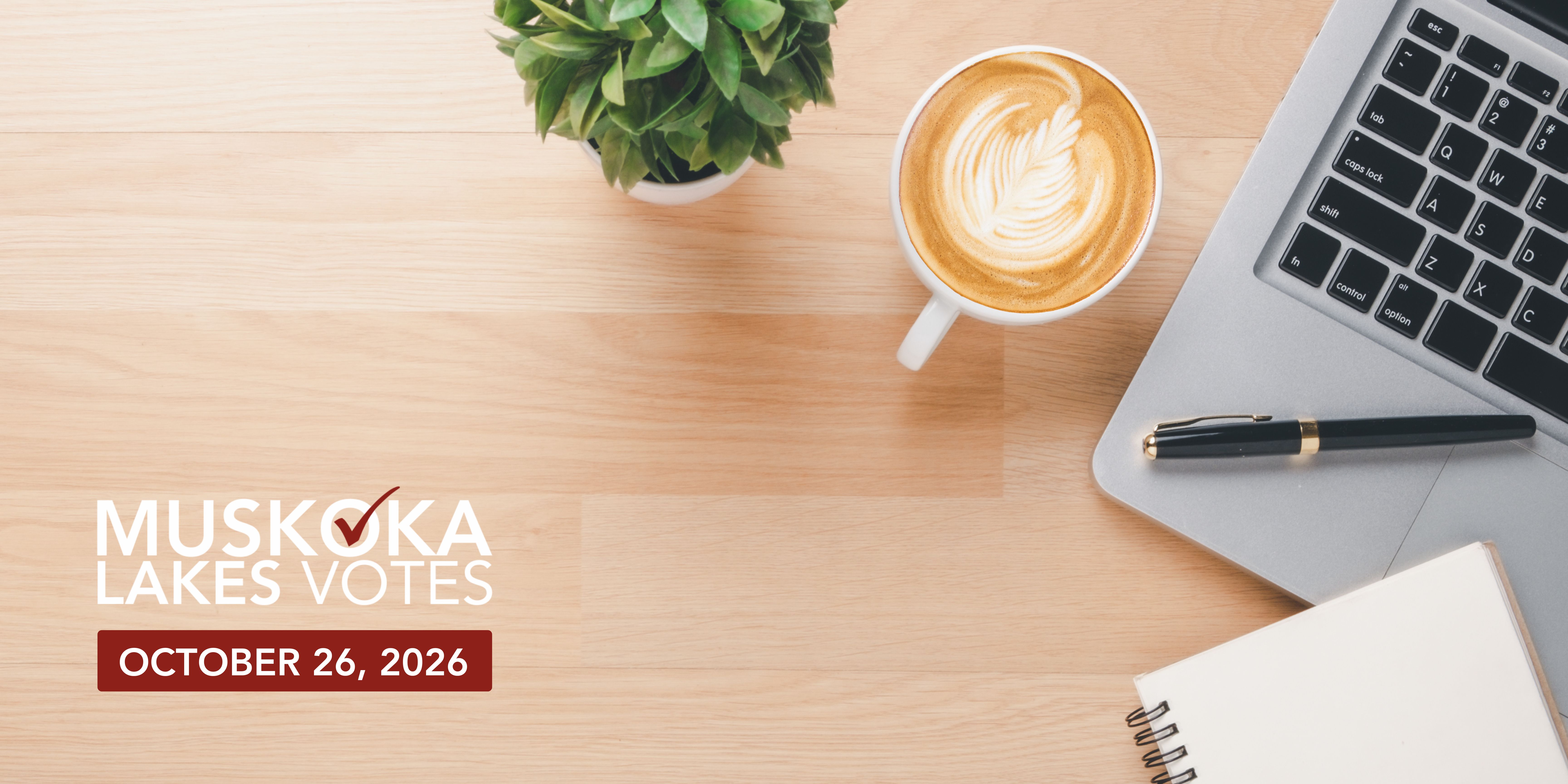 Aerial view of a desk with coffee and a computer and the muskoka lakes votes logo on October 26, 2026