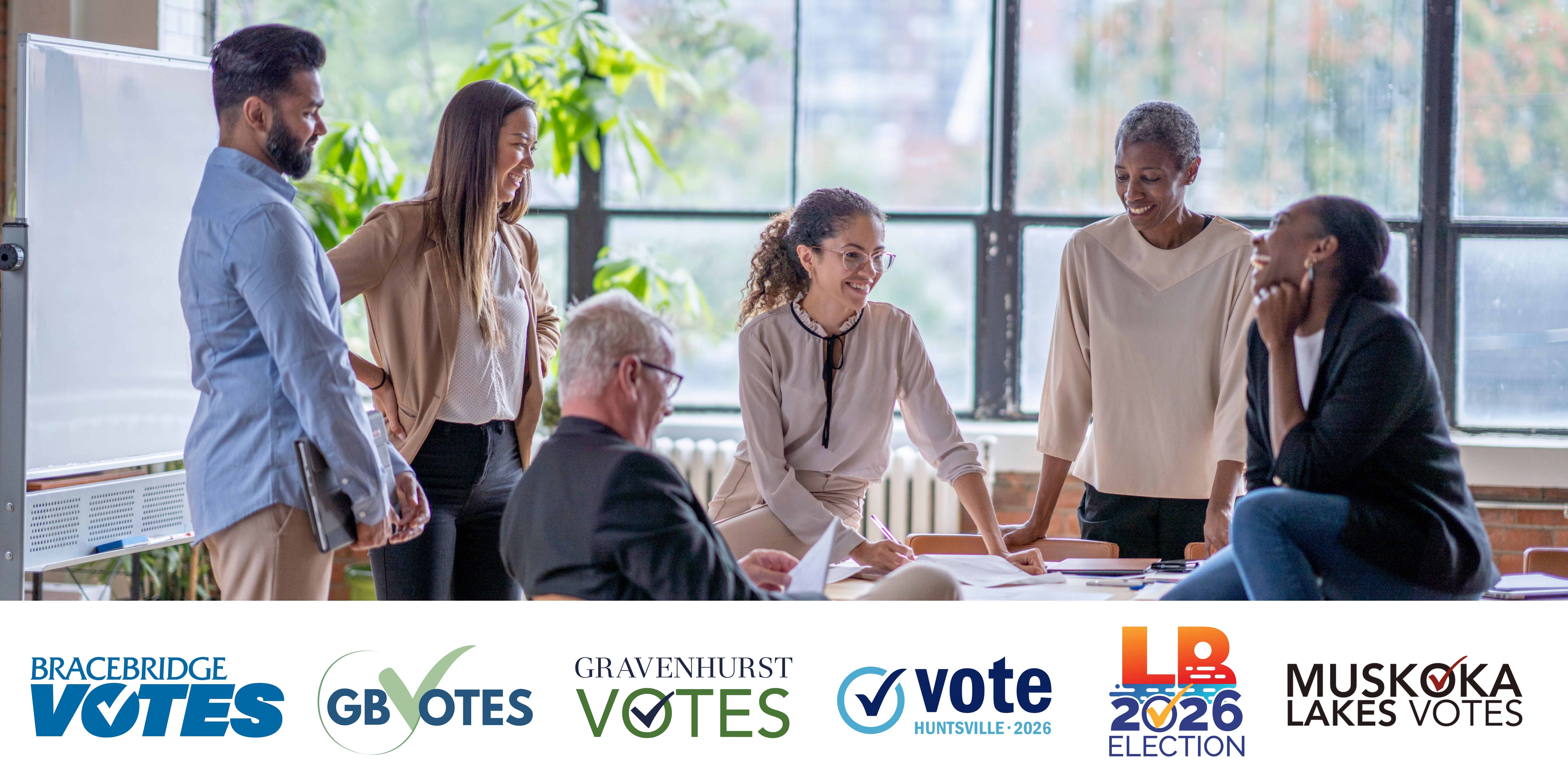 six people talking around a table with area municipality voting logos at the base
