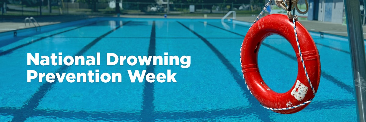 An outdoor swimming pool and lifeguard chair with white text "National Drowning Prevention Week".