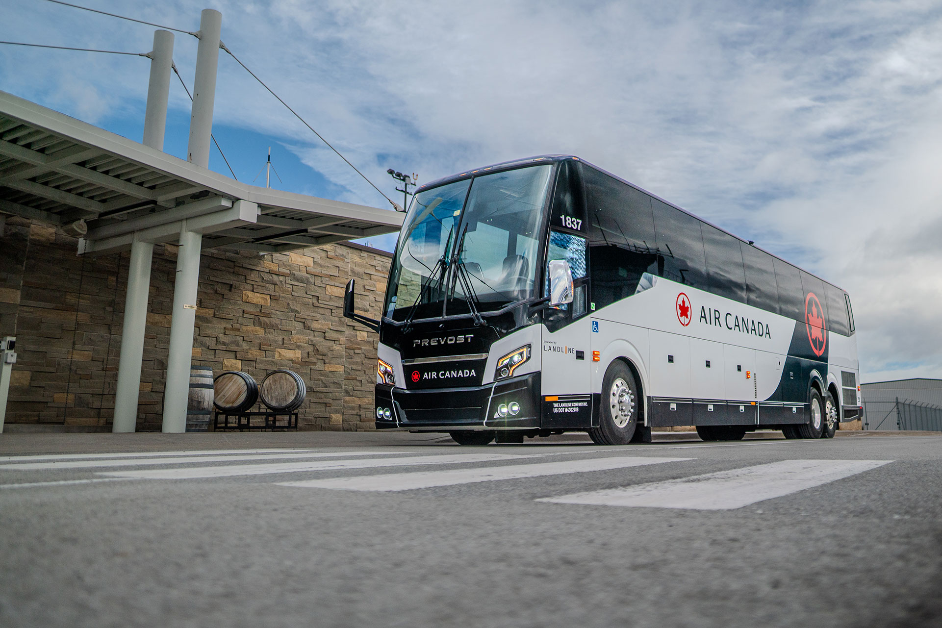 Air Canada motorcoach bus parked in front of the Niagara District Airport building.
