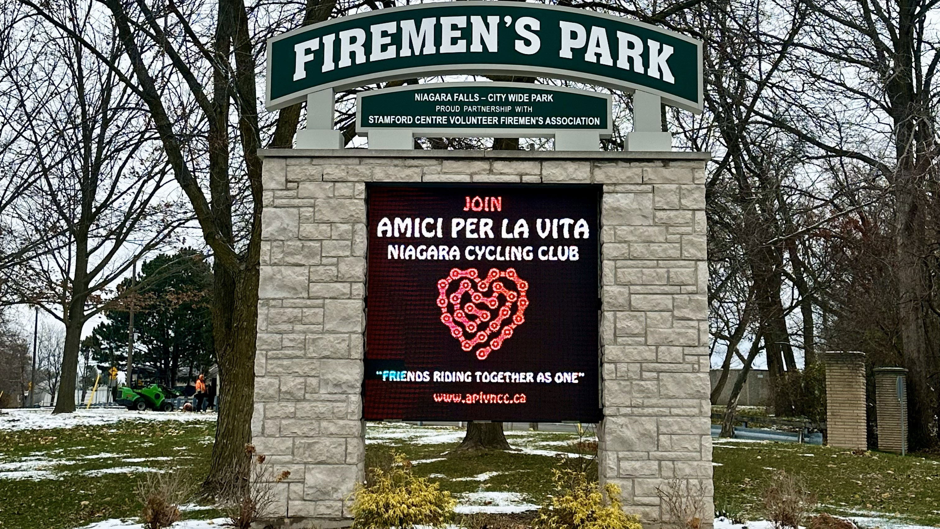 Firemen's Park sign showing a digital message on a wintery day.