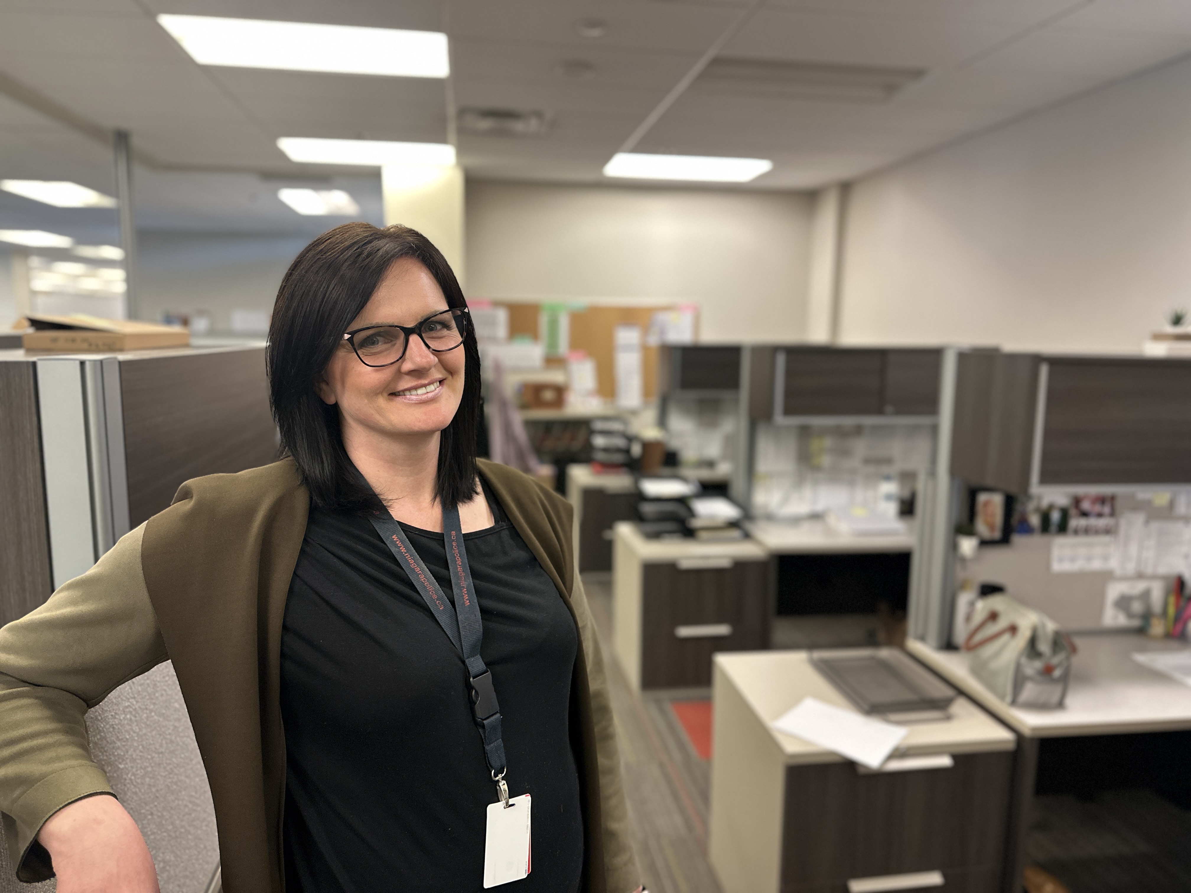 Civilian Niagara Regional Police Service employee standing in an office. 