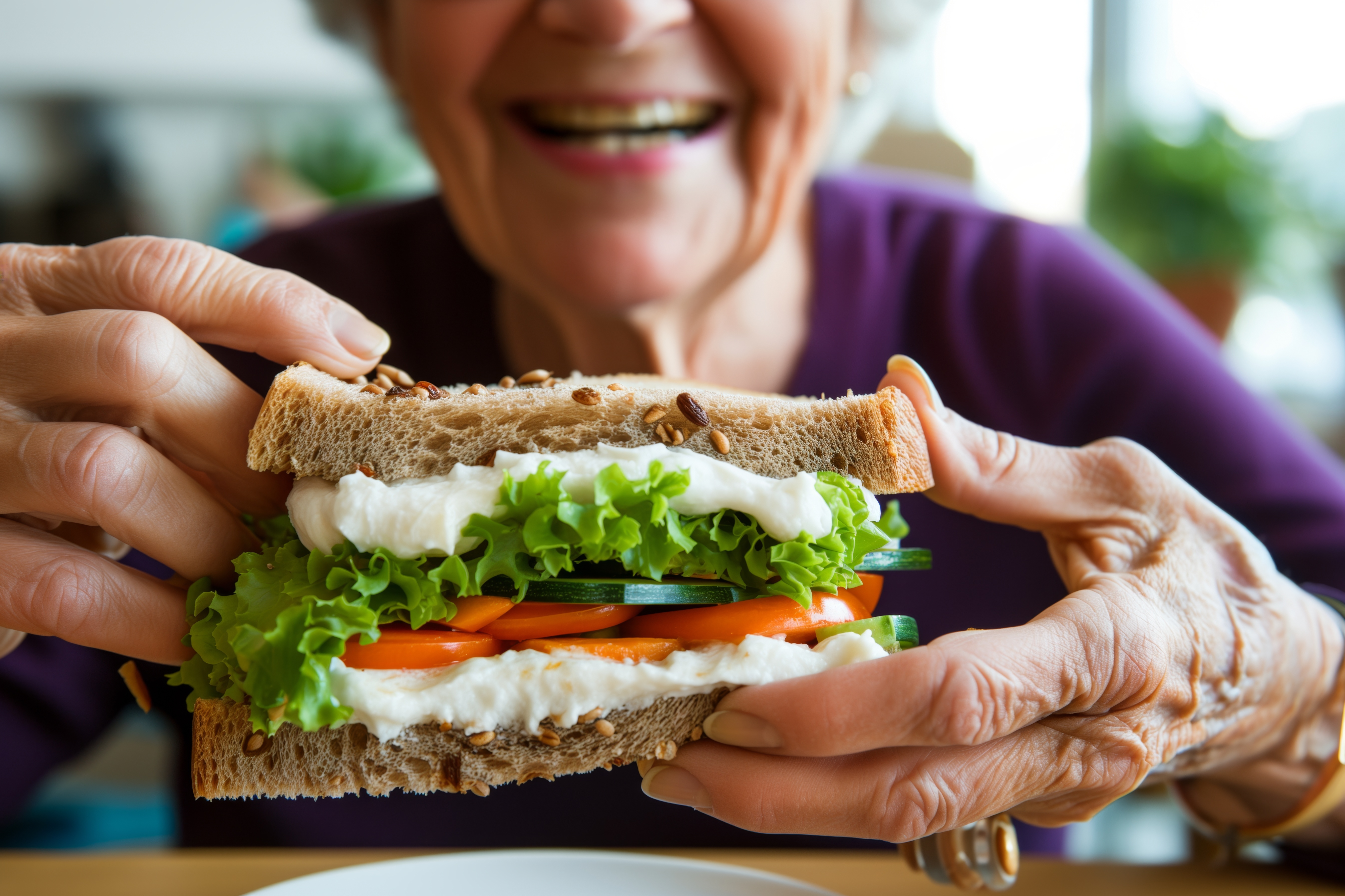 Senior holding sandwich and smiling