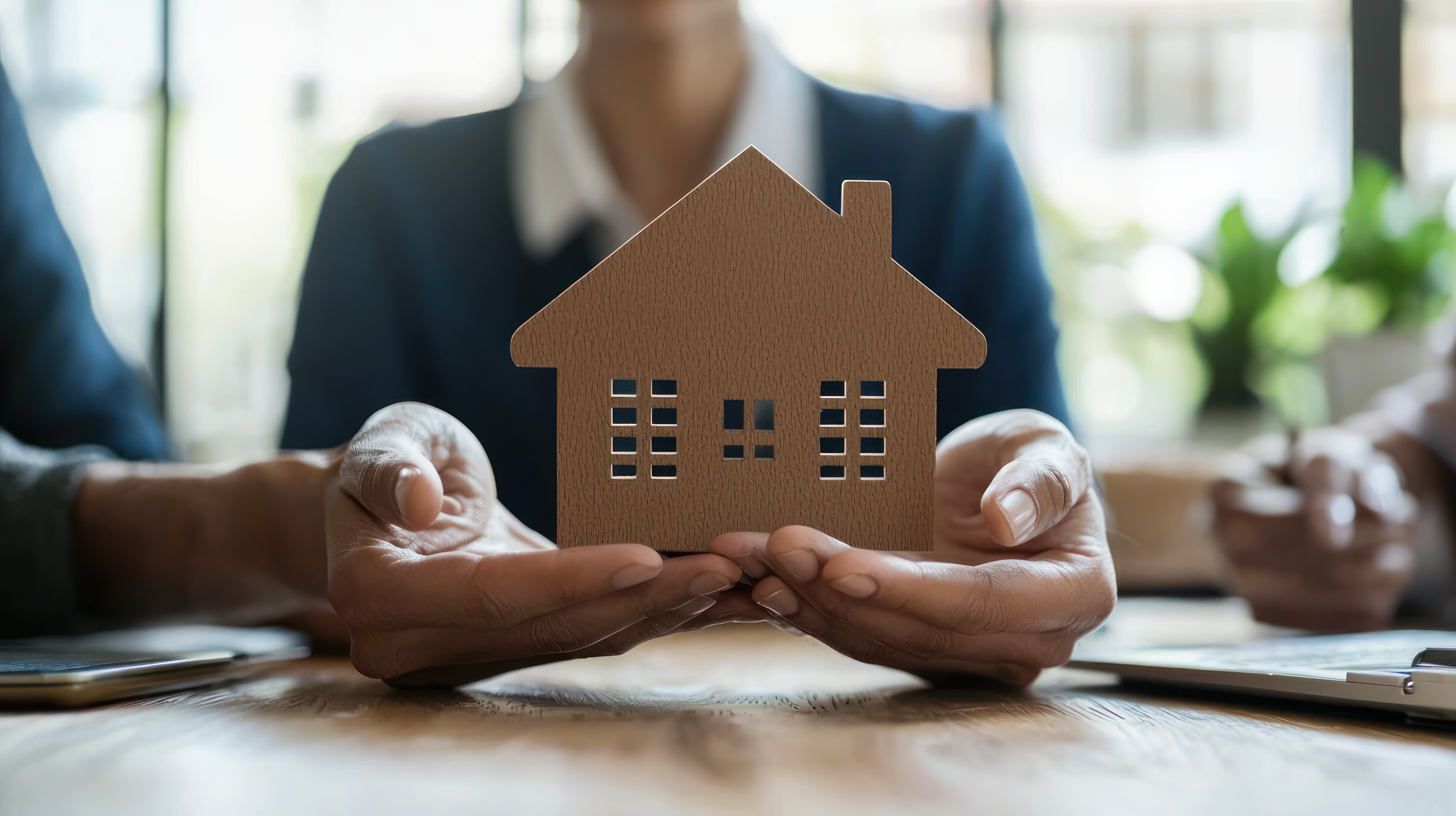 Person holding an outline of a house
