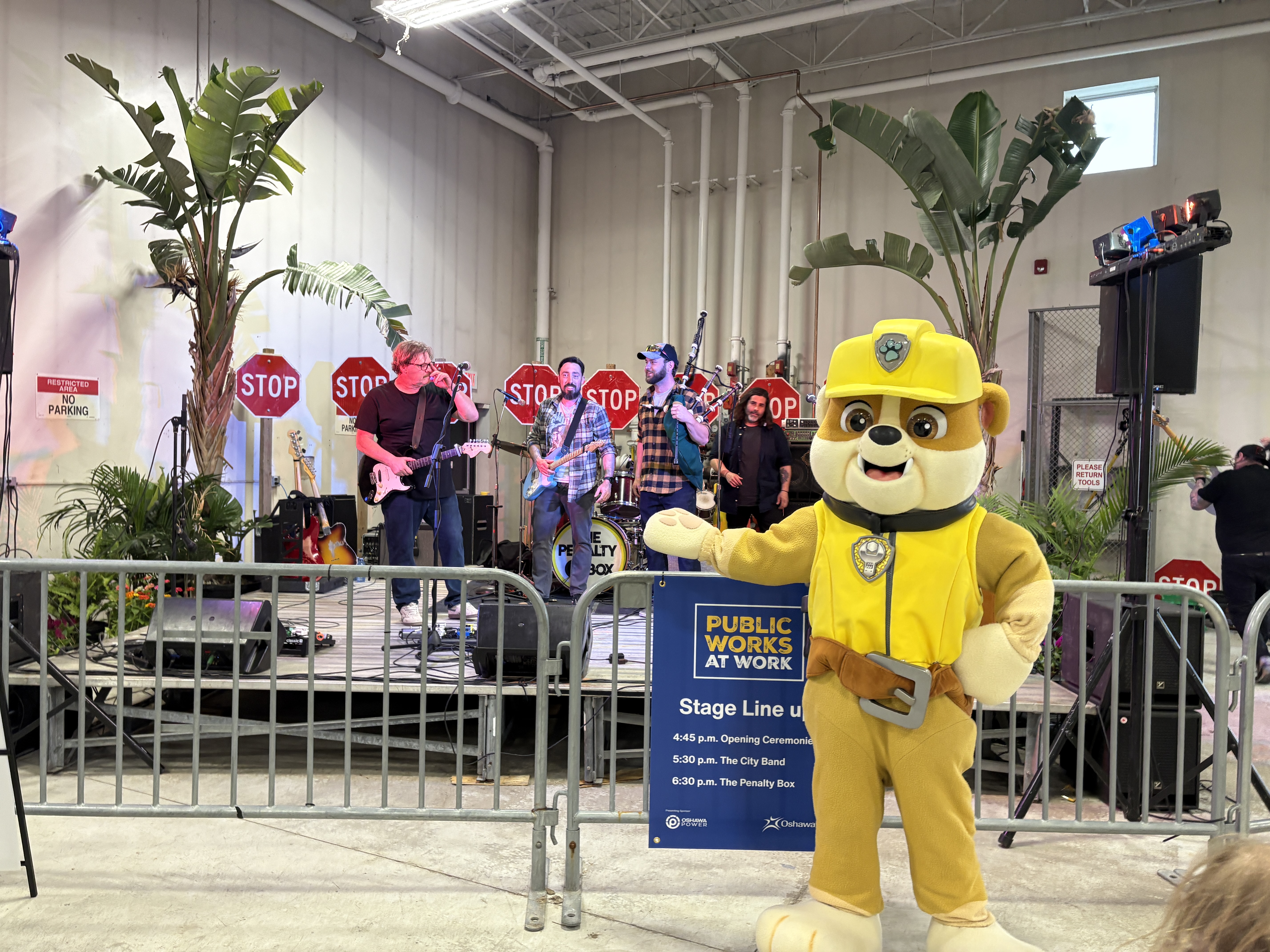 Paw Patrol costume character in front of stage with band