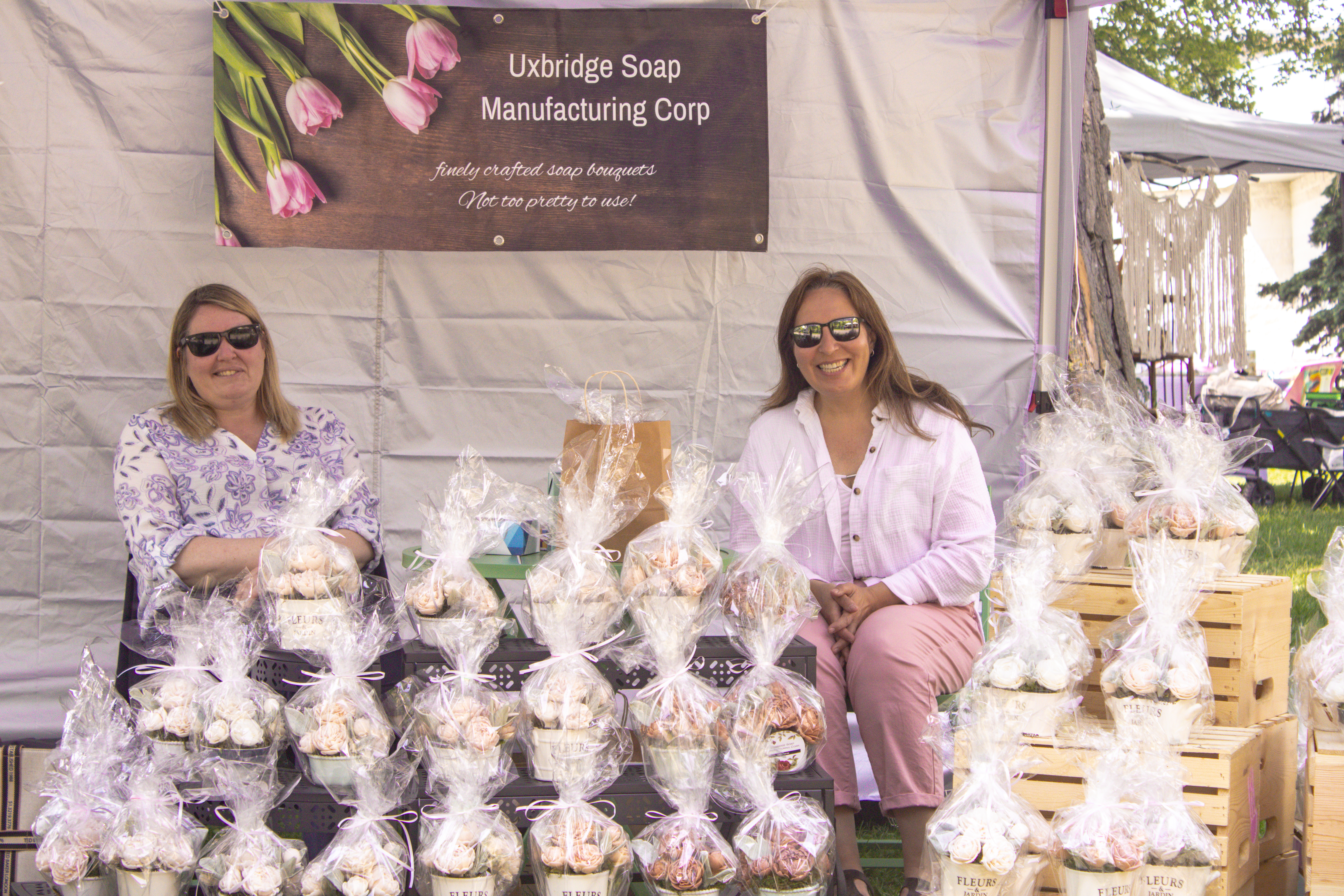 two women selling floral soap arrangements