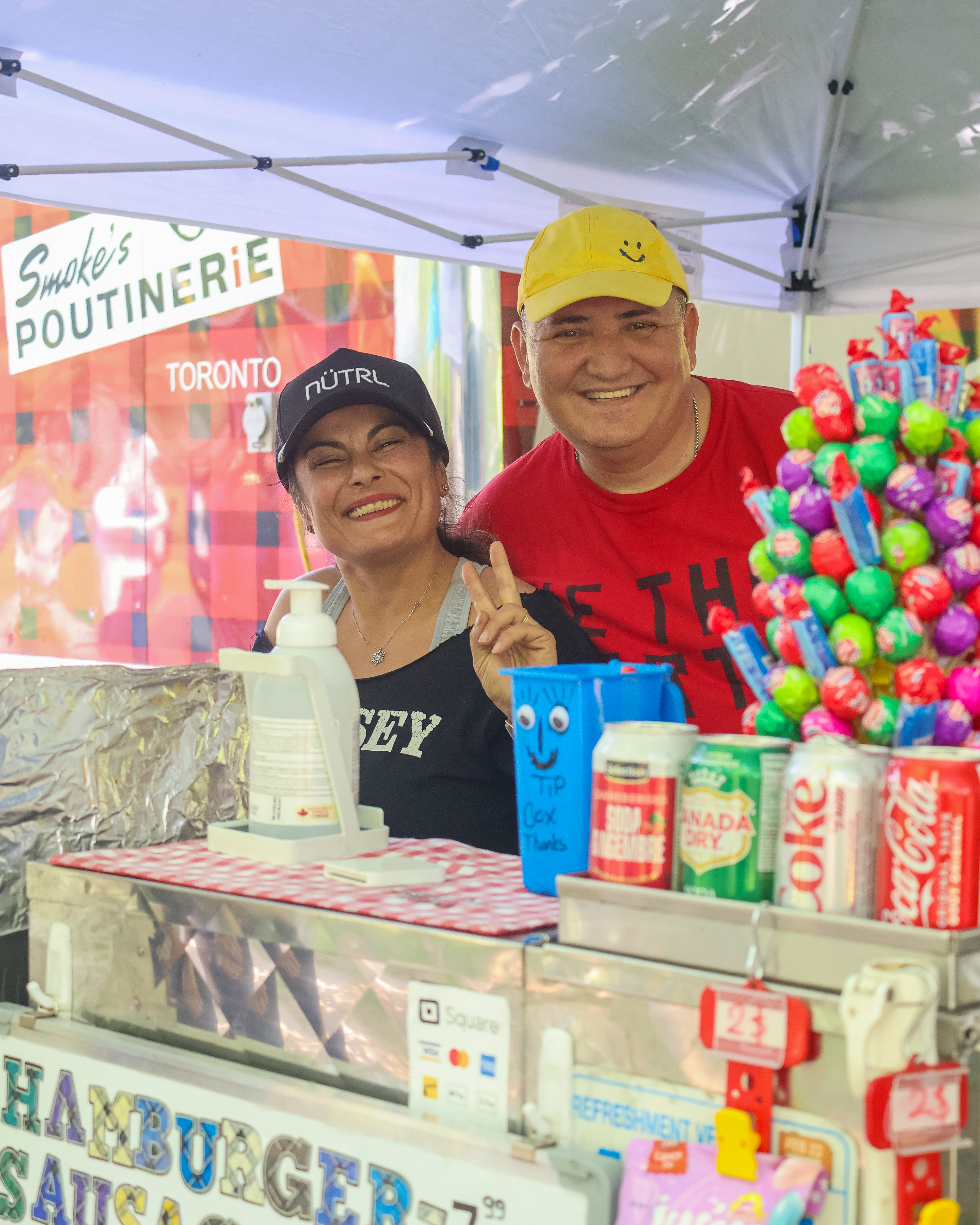 two hotdog vendors selling food