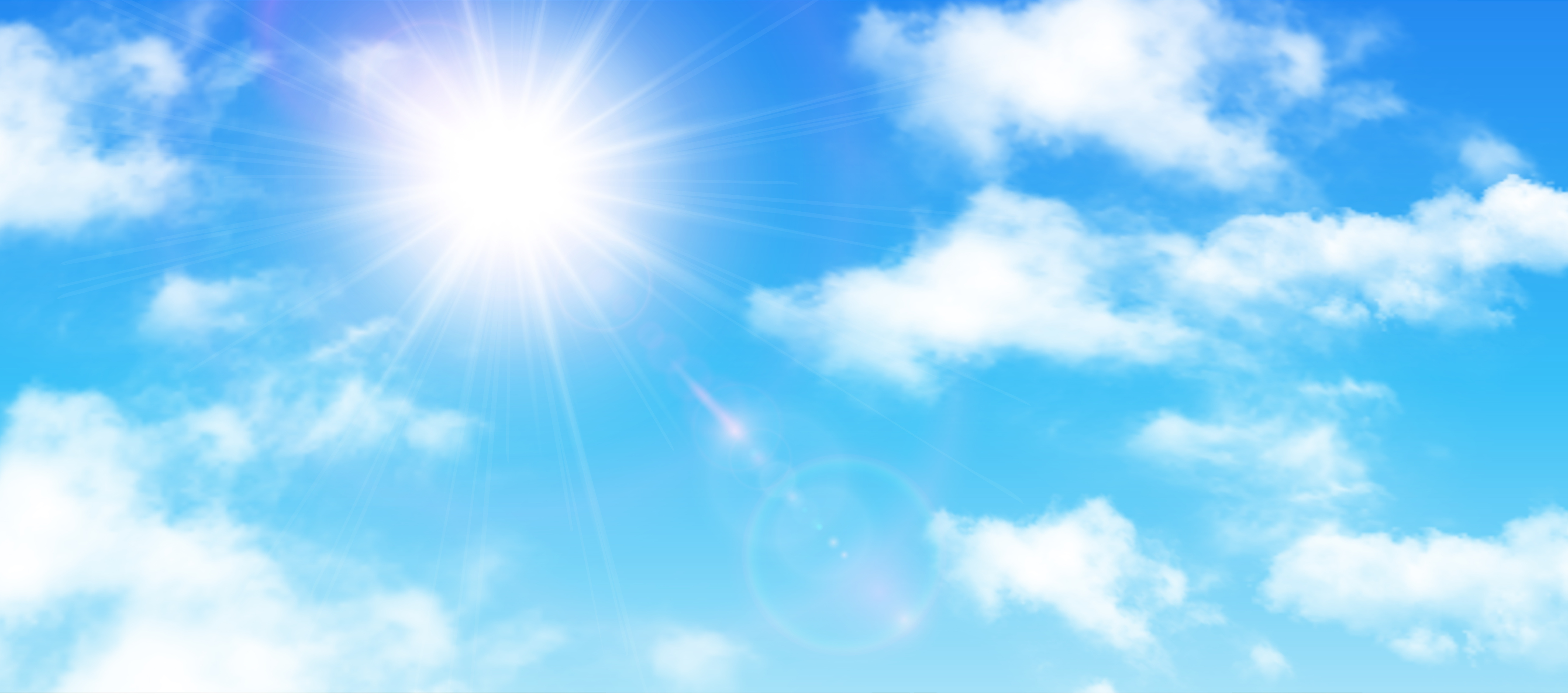 Bright sun in a blue sky with clouds