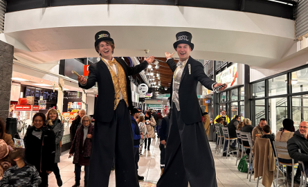 two stilt walkers with New Year's outfits