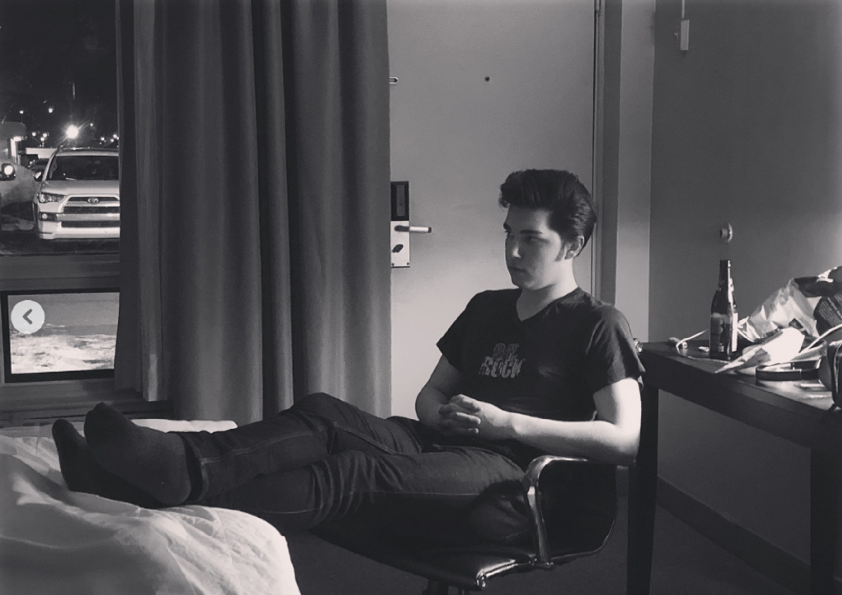 man sitting in chair in hotel room