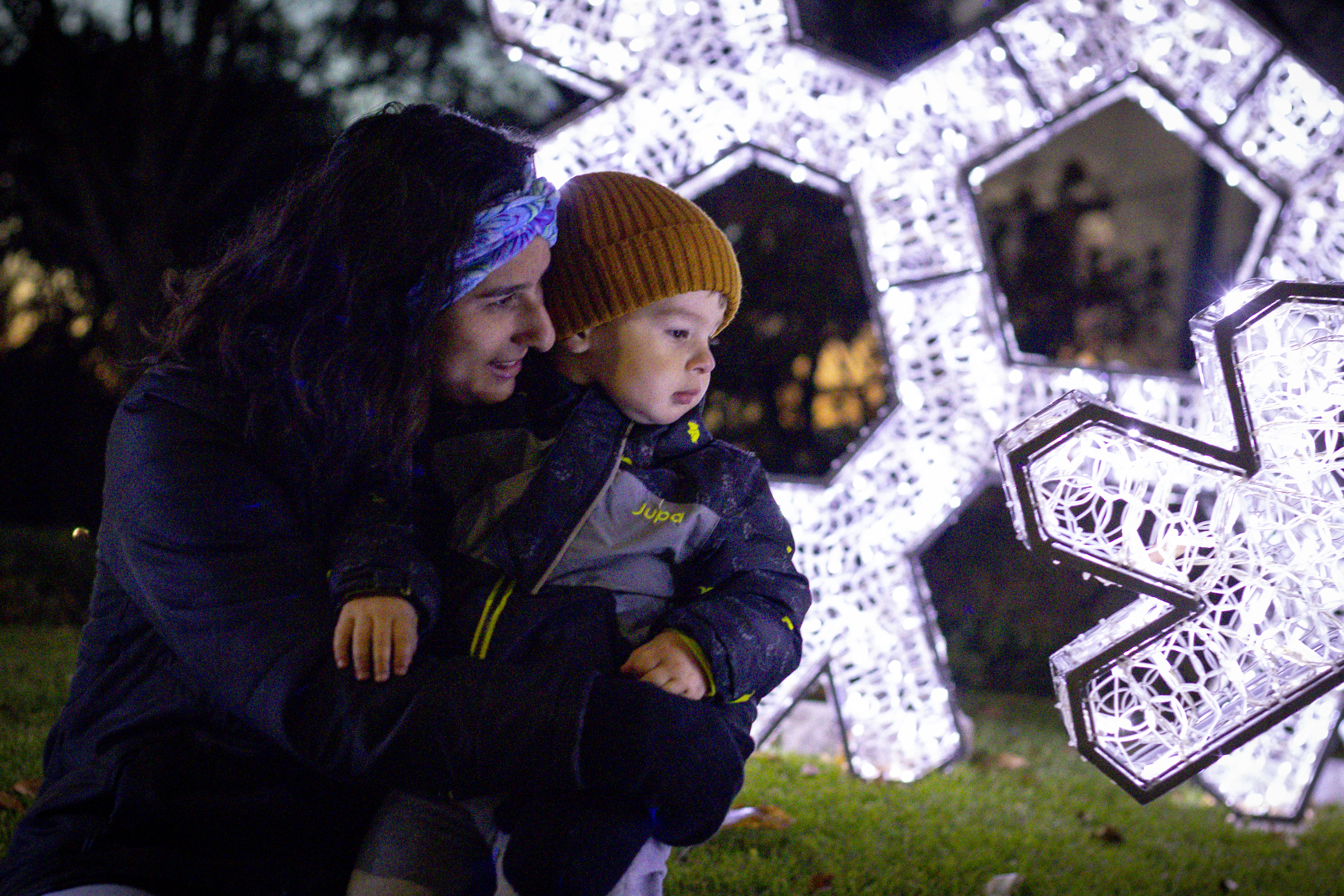 mother and young son looking at snowflake