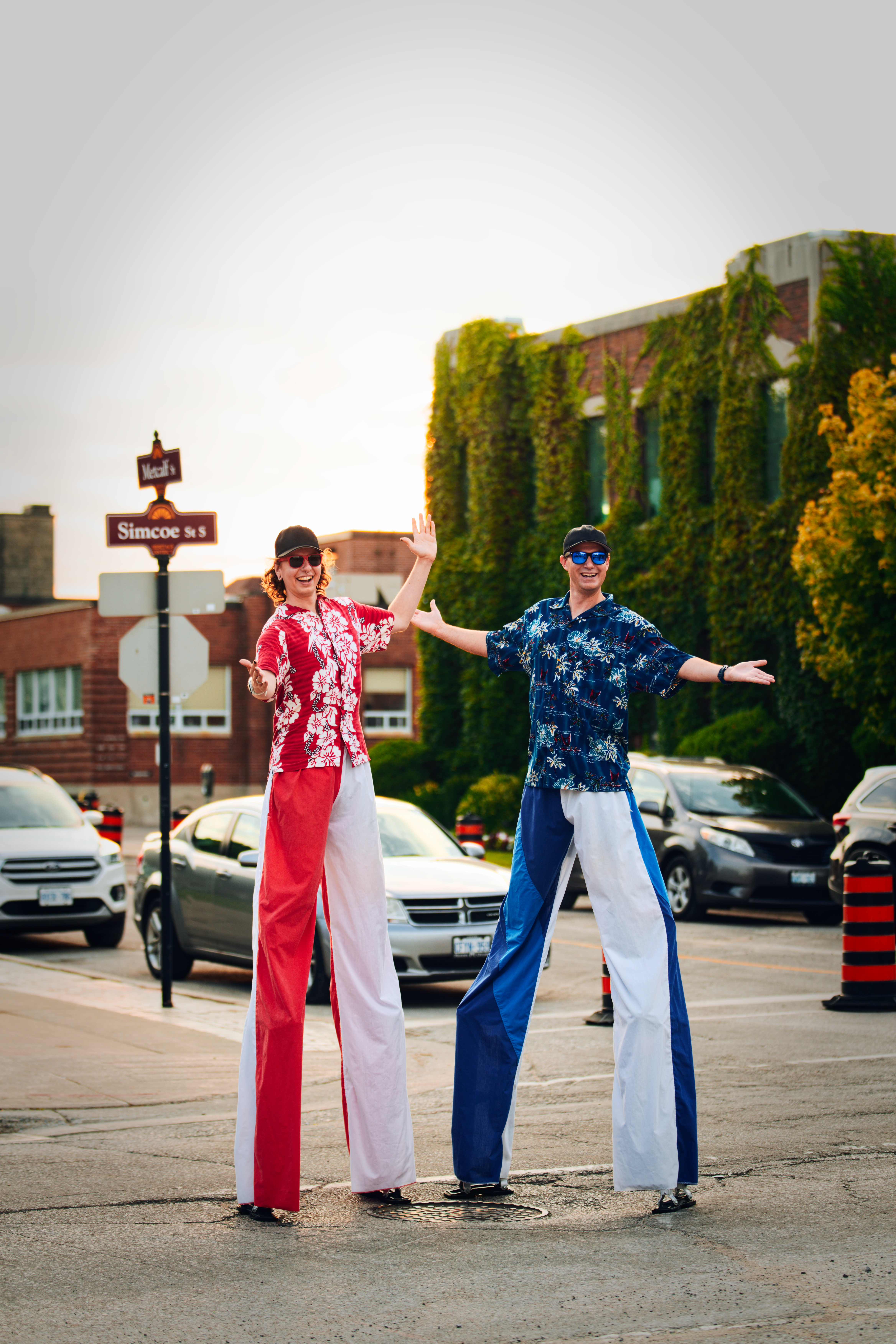 two stilt walkers on street posing at event
