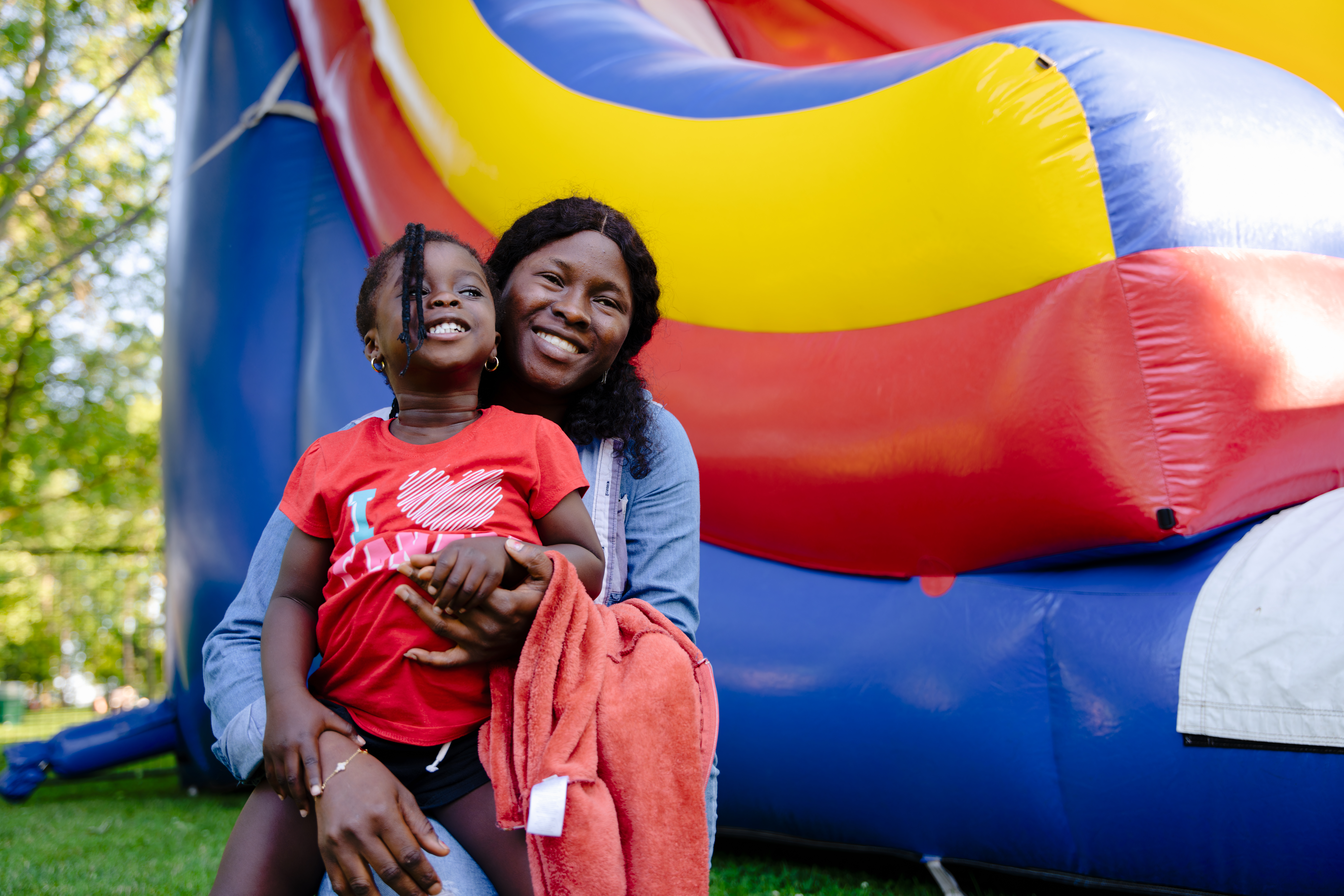 woman and child in front of bounce castle