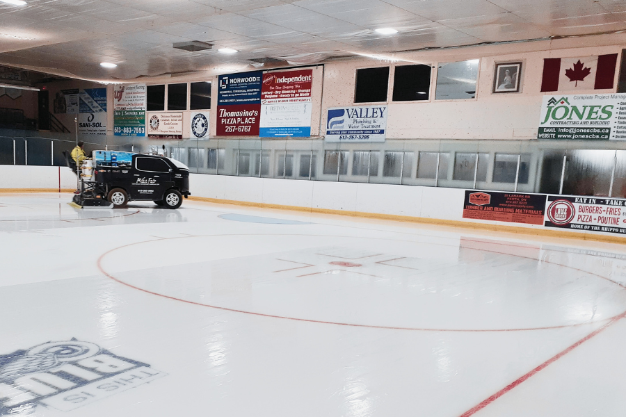 Zamboni going across ice on indoor arena