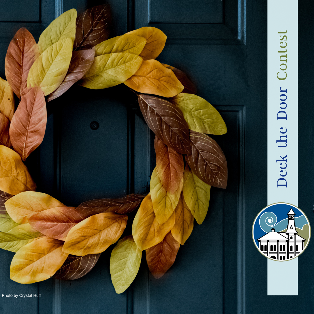Image of wreath on dark blue door text Shelburne Deck the Door Contest