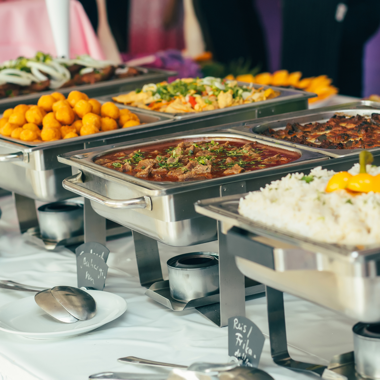 Buffet with hot food trays filled with various dishes