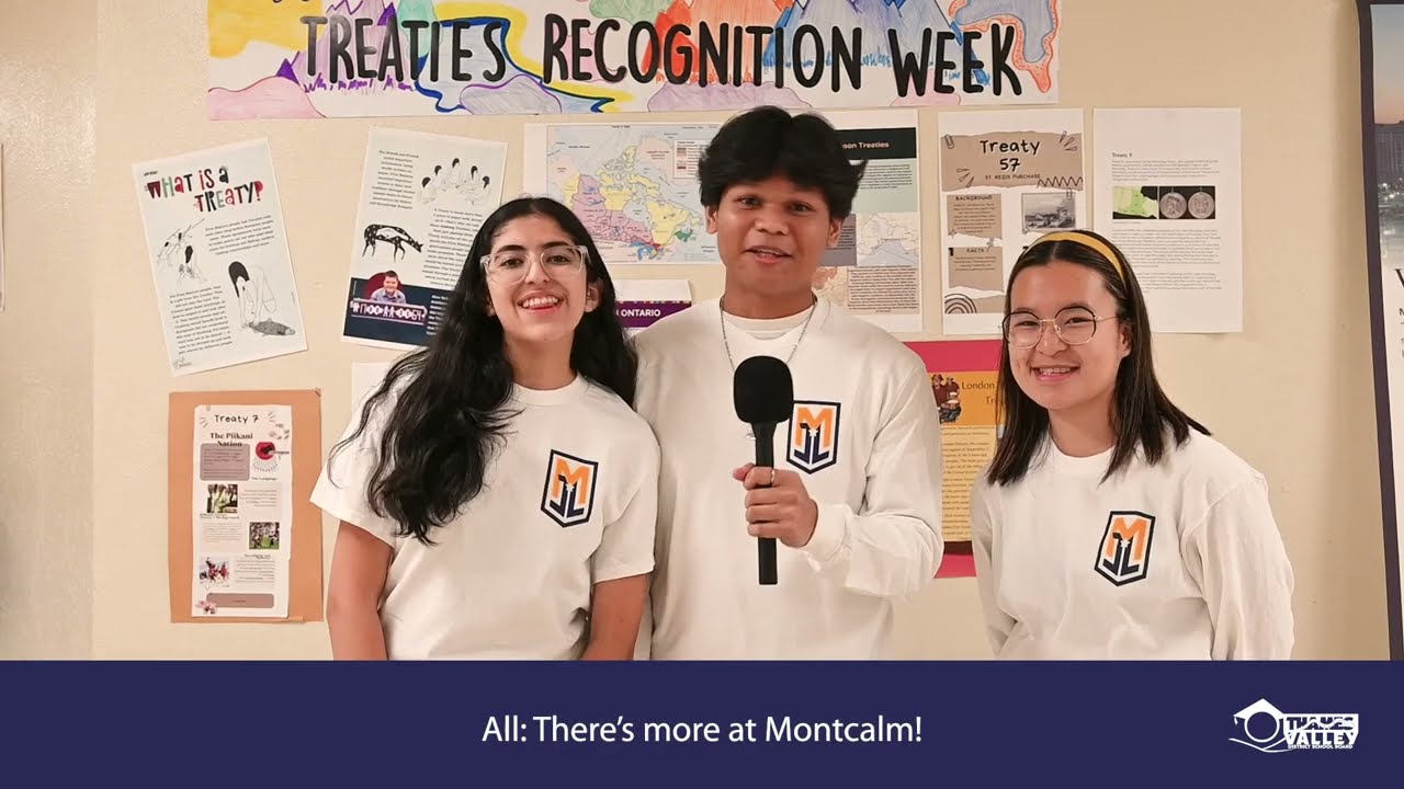 Three high school students hold microphones in front of Treaties Recognition Week poster