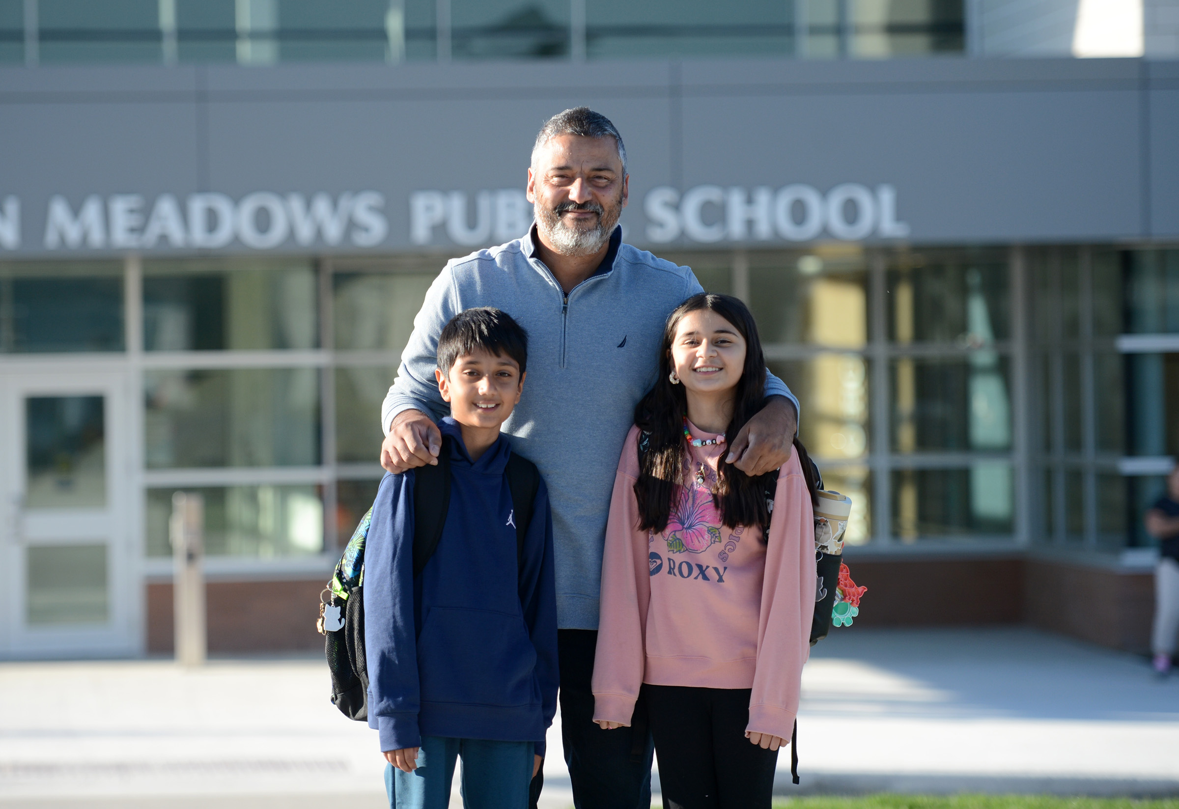A father with his two children on the first day of school at the new Jackson Meadows PS.