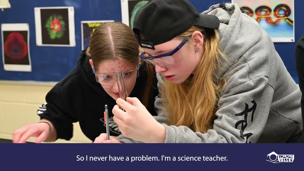 Two high school students conducting an experiment in a high school science lab